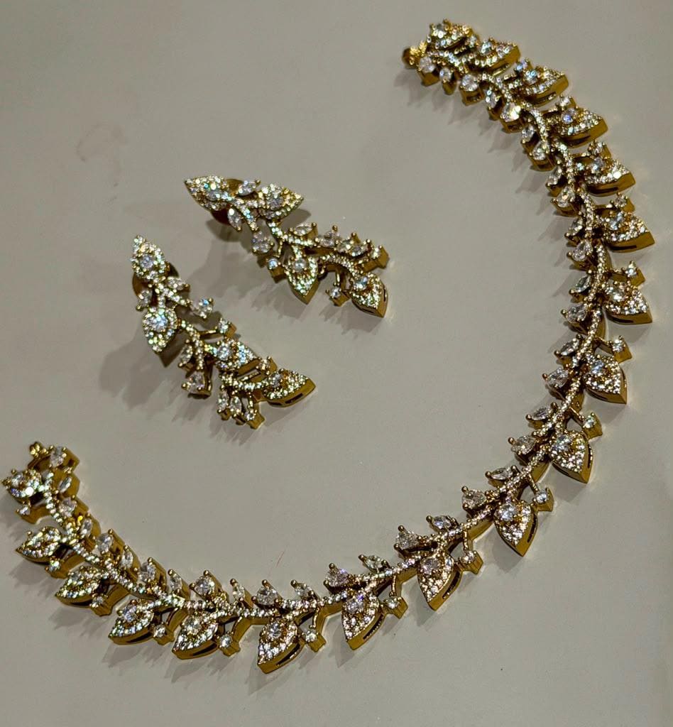 Elegant Antique Gold Finish Leaf Necklace and Earrings Set with Dazzling AD Stone Embellishment