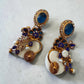 Ornate Blue Stone Drop Earrings with Iridescent AD Stones and Floral Gold Finish Design