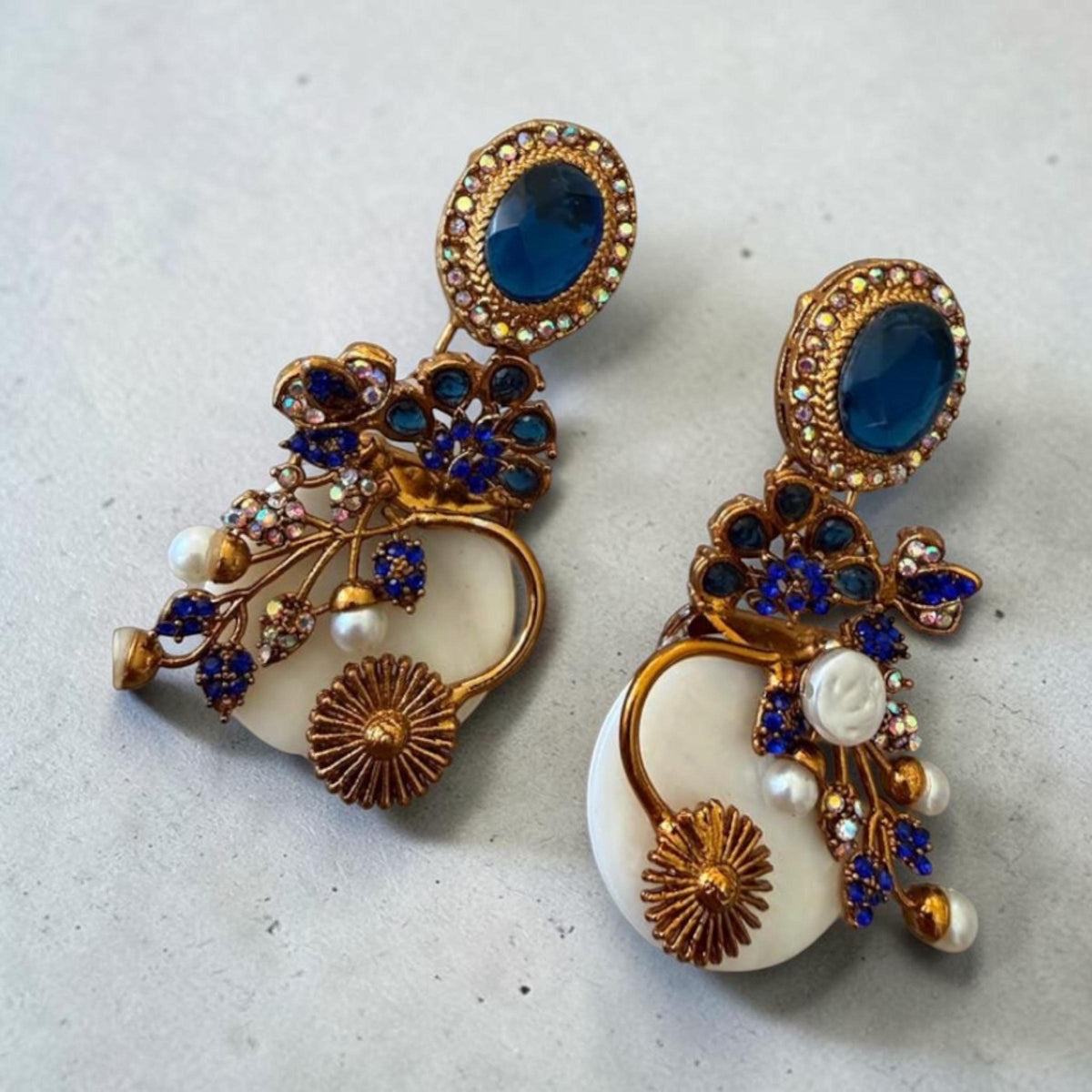 Ornate Blue Stone Drop Earrings with Iridescent AD Stones and Floral Gold Finish Design
